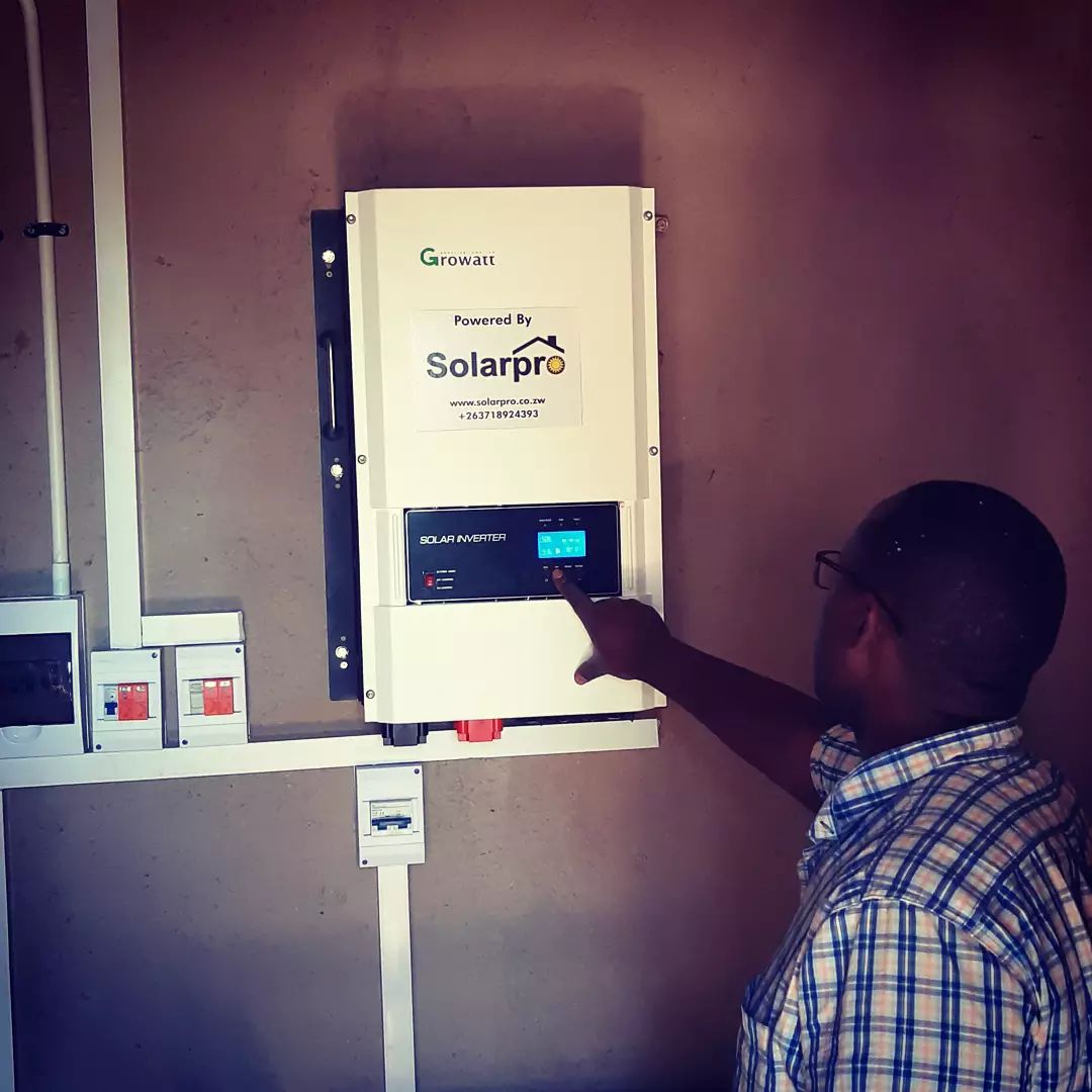 Solarpro technician reviewing inverter settings